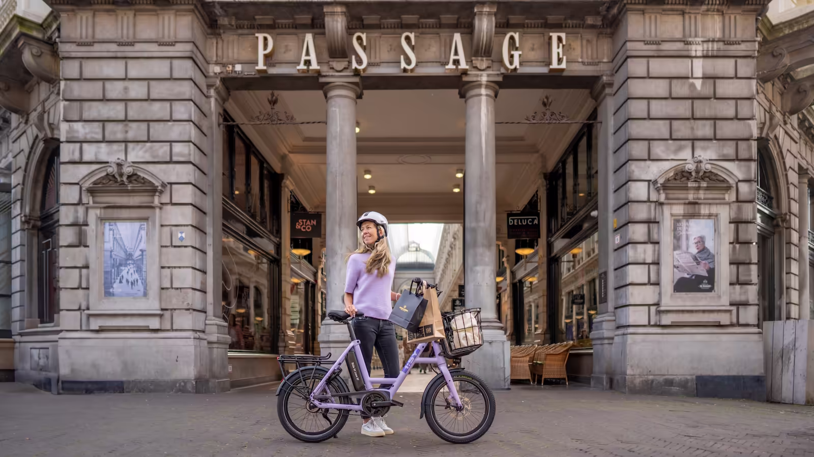 Das i:SY E5 ZR F Sondermodell in Pastel Purple vor dem historischen Eingang der Passage Den Haag